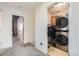 Convenient laundry area with stacked washer and dryer units and built-in storage at 19827 E Prentice Ave, Centennial, CO 80015