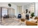 Inviting living room with modern decor, wood floors, and seamless transition to the dining area at 19827 E Prentice Ave, Centennial, CO 80015