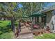 Back deck with outdoor seating and scenic views of the well-maintained yard at 31028 Big Bear Dr, Evergreen, CO 80439