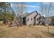 Spacious backyard featuring a wooden deck with outdoor seating, and mature trees at 31028 Big Bear Dr, Evergreen, CO 80439