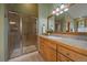 Bathroom with a glass enclosed shower, vanity, and a view to the outside at 31028 Big Bear Dr, Evergreen, CO 80439