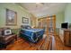 Bright bedroom with wood floors, vaulted ceilings, and view to the outside at 31028 Big Bear Dr, Evergreen, CO 80439