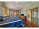 Inviting bedroom featuring hardwood floors, vaulted ceilings, and a view to the outside at 31028 Big Bear Dr, Evergreen, CO 80439