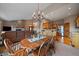 A spacious dining room featuring a stone fireplace and a view of the kitchen at 31028 Big Bear Dr, Evergreen, CO 80439