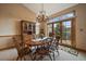 Cozy dining area with a wooden table, chandelier, and access to the deck at 31028 Big Bear Dr, Evergreen, CO 80439