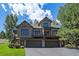 Stunning home exterior with a spacious three car garage at 31028 Big Bear Dr, Evergreen, CO 80439