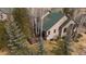 Charming home with a wooden deck surrounded by lush trees, offering privacy and tranquility at 31028 Big Bear Dr, Evergreen, CO 80439