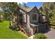 Two-story home featuring a well-manicured lawn, an attached garage and a stairway at 31028 Big Bear Dr, Evergreen, CO 80439