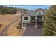 Aerial view of a beautiful house showcasing multi-car garage at 31028 Big Bear Dr, Evergreen, CO 80439