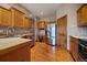 Bright kitchen with stainless steel appliances and wooden cabinets, complemented by hardwood flooring at 31028 Big Bear Dr, Evergreen, CO 80439