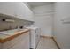 Well-organized laundry room with sink, storage cabinets, washer, and dryer at 31028 Big Bear Dr, Evergreen, CO 80439