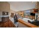 Inviting living room with a stone fireplace, hardwood flooring and dining area at 31028 Big Bear Dr, Evergreen, CO 80439