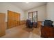 Study with wood trim, neutral walls, and large wooden door at 31028 Big Bear Dr, Evergreen, CO 80439