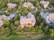 Aerial view of a backyard oasis featuring a deck, firepit, mature trees, and lush landscaping, perfect for entertaining at 6279 Oxford Peak Pl, Castle Rock, CO 80108