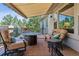 Relaxing backyard deck featuring comfortable seating, a fire table, and a retractable awning for shade and enjoyment at 6279 Oxford Peak Pl, Castle Rock, CO 80108