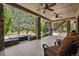 Covered backyard patio with stone pillars, a hot tub, and comfortable seating, ideal for outdoor entertaining at 6279 Oxford Peak Pl, Castle Rock, CO 80108