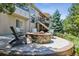 Backyard patio featuring a stone fire pit and Adirondack chairs, perfect for cozy outdoor gatherings at 6279 Oxford Peak Pl, Castle Rock, CO 80108