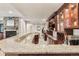 Granite bar with custom cabinetry, wine rack and display shelves in basement, perfect for entertaining at 6279 Oxford Peak Pl, Castle Rock, CO 80108