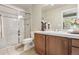 Bathroom showcasing a glass-enclosed shower, vanity with candles, and neutral-toned tile flooring at 6279 Oxford Peak Pl, Castle Rock, CO 80108
