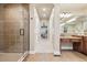 Hallway featuring glass enclosed shower and large vanity at 6279 Oxford Peak Pl, Castle Rock, CO 80108