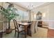 Elegant dining room with a chandelier, large window, and classic decor, perfect for entertaining at 6279 Oxford Peak Pl, Castle Rock, CO 80108
