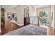 Bright entryway featuring wood floors, decorative mirror, and staircase with large window providing ample natural light at 6279 Oxford Peak Pl, Castle Rock, CO 80108