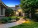 Charming home with landscaped front yard, stone accents, and inviting entryway lighting at 6279 Oxford Peak Pl, Castle Rock, CO 80108