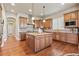 Spacious kitchen boasts wood floors, stainless steel appliances, and a center island at 6279 Oxford Peak Pl, Castle Rock, CO 80108