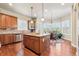 Stylish kitchen with granite island, wood floors, stainless steel appliances, and a breakfast nook with abundant natural light at 6279 Oxford Peak Pl, Castle Rock, CO 80108