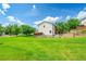 Expansive backyard with lush green grass and a wooden fence, perfect for recreation at 215 Mcafee Cir, Erie, CO 80516