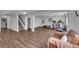 Open basement area featuring hardwood floors, workout equipment, and a cozy seating area at 215 Mcafee Cir, Erie, CO 80516