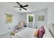 Bright bedroom with white walls, large window and a plush armchair at 215 Mcafee Cir, Erie, CO 80516