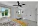 Bright bedroom featuring two windows, white walls, and a bench with a fur throw at 215 Mcafee Cir, Erie, CO 80516