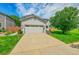 Two-story home with a two-car garage, well maintained lawn and landscaping in a suburban neighborhood at 215 Mcafee Cir, Erie, CO 80516