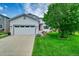 Charming two-story home featuring a well-manicured lawn, a two-car garage and a vibrant red front door at 215 Mcafee Cir, Erie, CO 80516