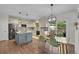 Modern kitchen boasts stainless steel appliances, center island, and eat in kitchen area with sliding glass door at 215 Mcafee Cir, Erie, CO 80516
