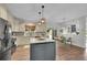 Bright kitchen offers stainless steel appliances, kitchen island, and views of both the backyard and living spaces at 215 Mcafee Cir, Erie, CO 80516