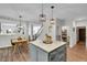 Open-concept home with view of kitchen island, eat-in kitchen, stairway, and living areas at 215 Mcafee Cir, Erie, CO 80516