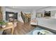 Open-concept living room featuring wood floors, dining area, stairs to second story, and neutral decor at 215 Mcafee Cir, Erie, CO 80516