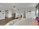 Bright primary bedroom featuring ceiling fan, en suite bathroom, dresser, and modern decor at 215 Mcafee Cir, Erie, CO 80516