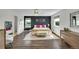 Sun-lit primary bedroom featuring contemporary decor and view of the en suite bathroom at 215 Mcafee Cir, Erie, CO 80516