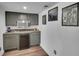 Cozy wet bar with modern gray cabinets, stainless steel microwave, and beverage cooler at 215 Mcafee Cir, Erie, CO 80516
