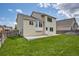 Well-maintained backyard with lush lawn, patio, and view of the rear of the house at 245 Homestead Way, Brighton, CO 80601