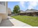 Well-maintained backyard with lush lawn, patio, and wood fence at 245 Homestead Way, Brighton, CO 80601