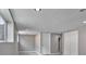 Basement features multiple windows, neutral paint, plush carpeting, white trim, and an access door at 245 Homestead Way, Brighton, CO 80601