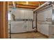 Basement features a window, exposed utilities, unfinished ceiling, storage cabinets, and a heater at 245 Homestead Way, Brighton, CO 80601