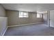 Spacious basement featuring two windows, neutral paint, and carpeted flooring provides versatile living space at 245 Homestead Way, Brighton, CO 80601