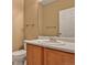 Bathroom featuring a sink vanity, toilet, and door at 245 Homestead Way, Brighton, CO 80601