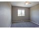Cozy bedroom featuring neutral paint, plush carpeting, a ceiling fan, and a window at 245 Homestead Way, Brighton, CO 80601
