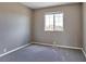 Cozy bedroom featuring gray carpet, a large window, and fresh paint at 245 Homestead Way, Brighton, CO 80601